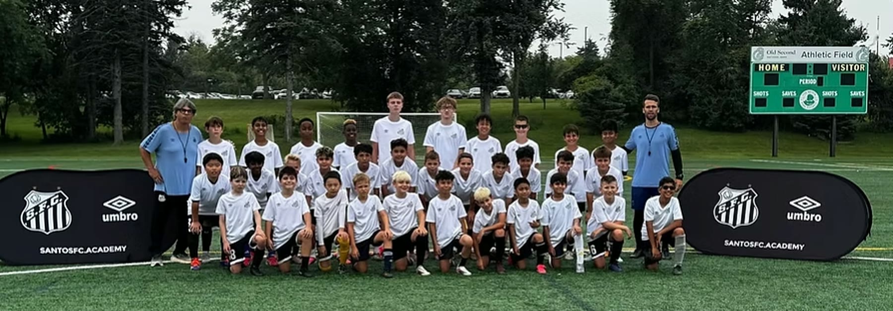 WCOB FC summer camp players and coaches posed on the turf after a session