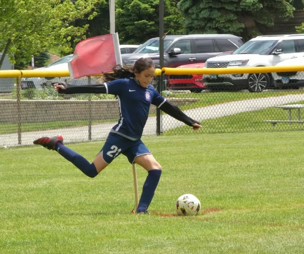 WCOB player striking the ball during a Super Y League match